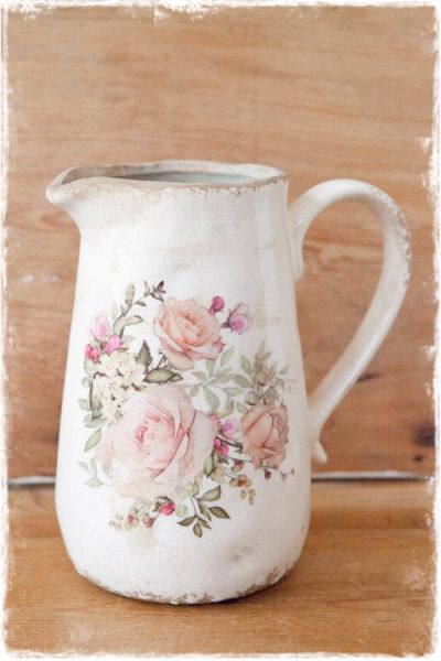brocante crème waterkan van keramiek met een afbeelding van roze bloemen aan beide zijden 